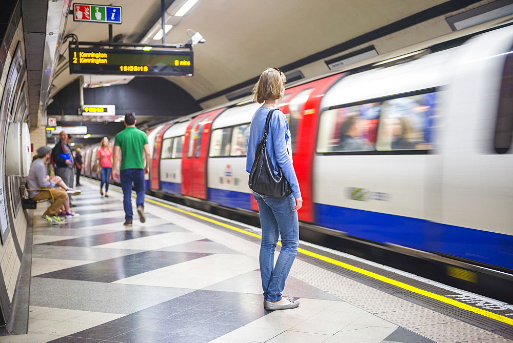 Person waiting at Waterloo underground station for the tube, London, England, United Kingdom, Europe