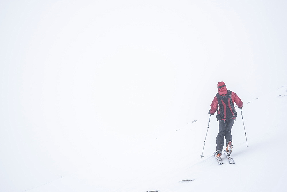 Ski touring in a snow blizzard white out at CairnGorm Mountain Ski Resort, Cairngorms National Park, Scotland, United Kingdom, Europe