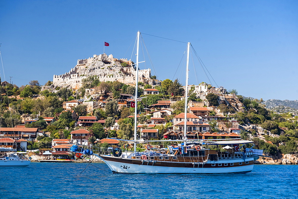 Simena Castle and Gulet sailing boat seen from Kekova Bay, Antalya Province, Lycia, Anatolia, Mediterranean Sea, Turkey, Asia Minor, Eurasia