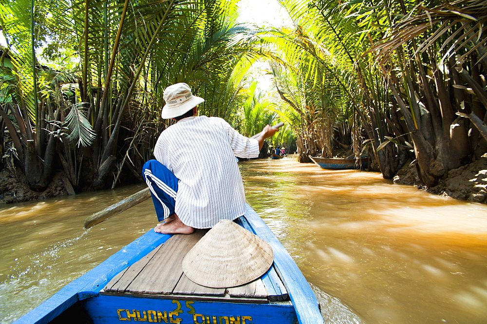 Boat trip up a narrow river in the Mekong Delta, Vietnam, Indochina, Southeast Asia, Asia