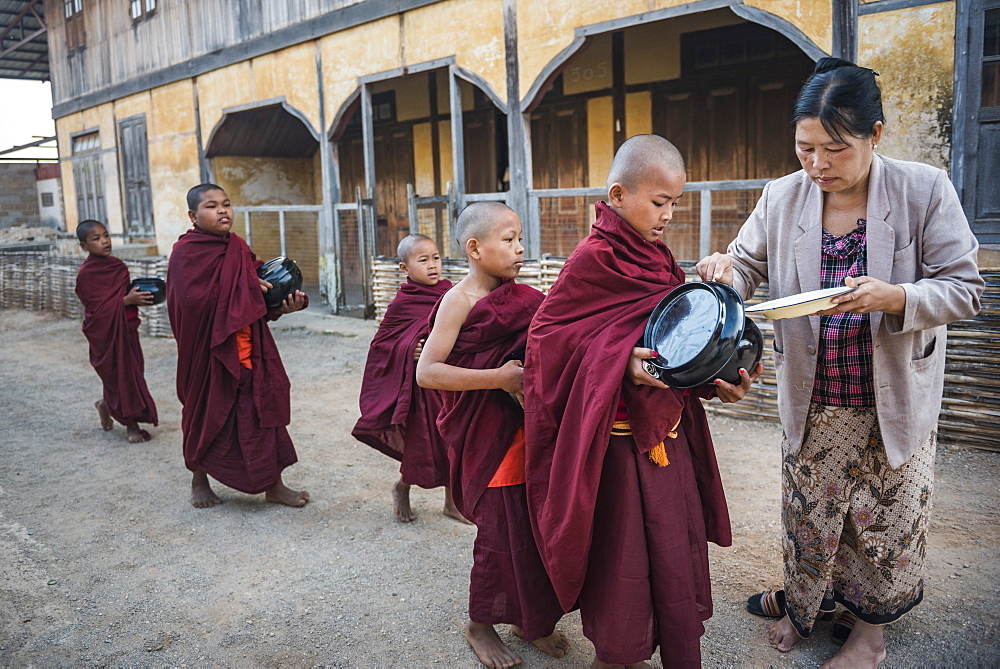 Young novice monks collecting alms at Pindaya, Shan State, Myanmar (Burma), Asia