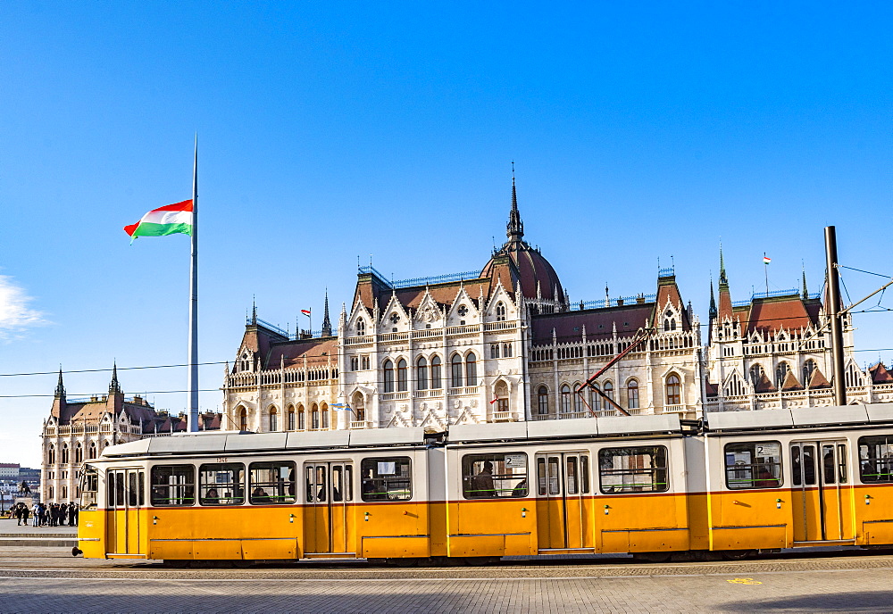 Houses of Parliament and yellow tram, Budapest, Hungary, Europe