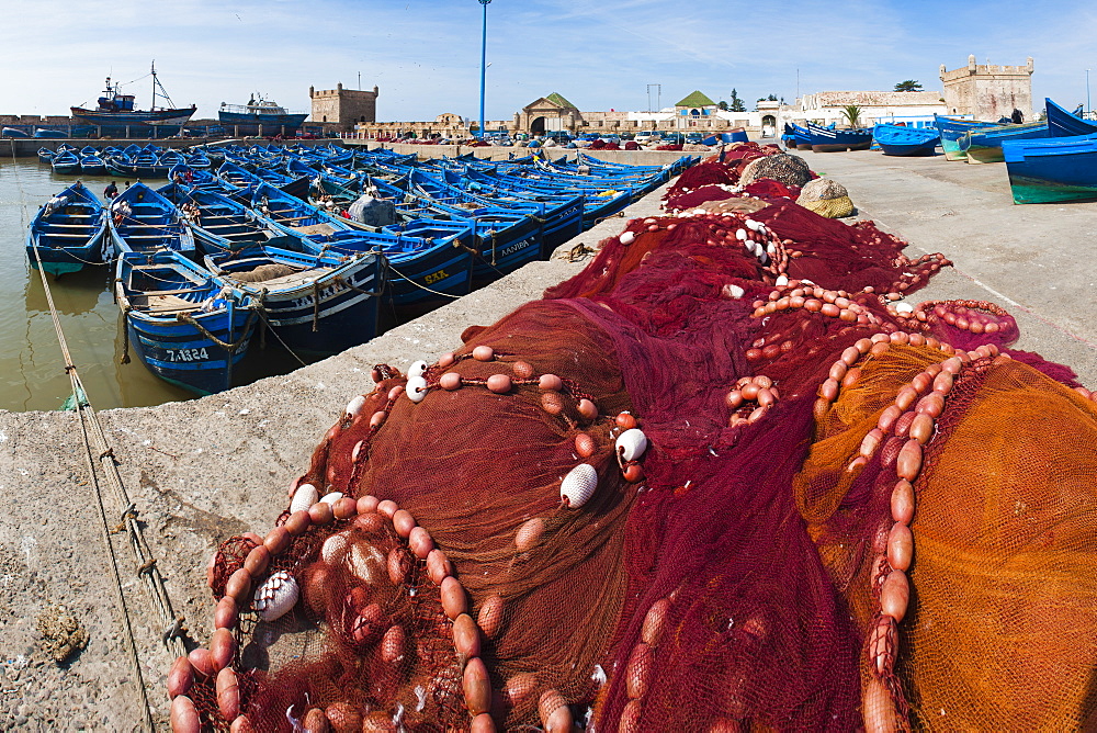 Fishing nets and blue fishing boats in Essaouira Port, formerly Mogador, Morocco, North Africa, Africa 