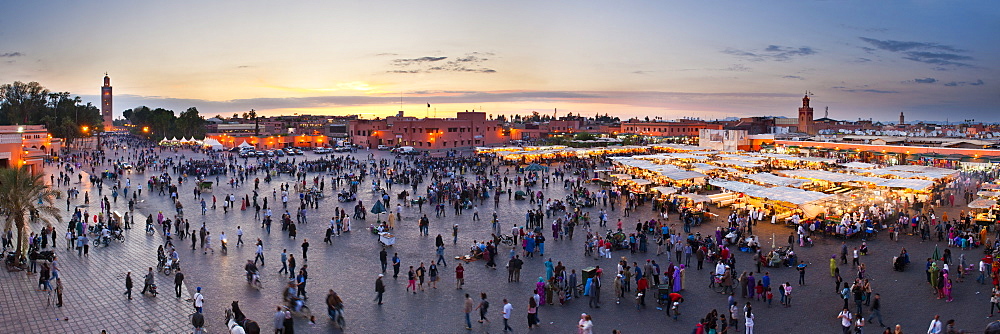 Food stalls, people and Koutoubia Mosque at sunset, Place Djemaa el Fna, Marrakech, Morocco, North Africa, Africa 