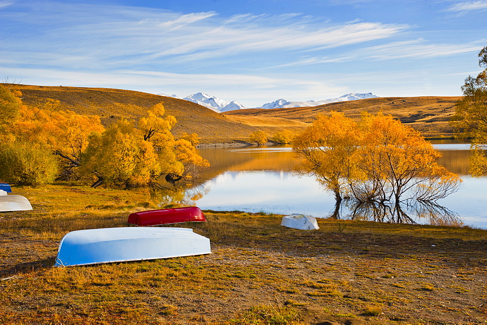 Rowing boats and snow capped mountains at Lake Alexandrina, Southern Lakes, Otago Region, South Island, New Zealand, Pacific