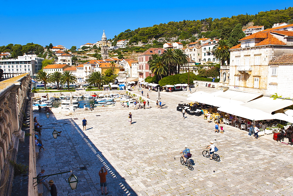 Cafes and tourists in St. Stephens Square, Hvar Town, Hvar Island, Dalmatian Coast, Croatia, Europe 