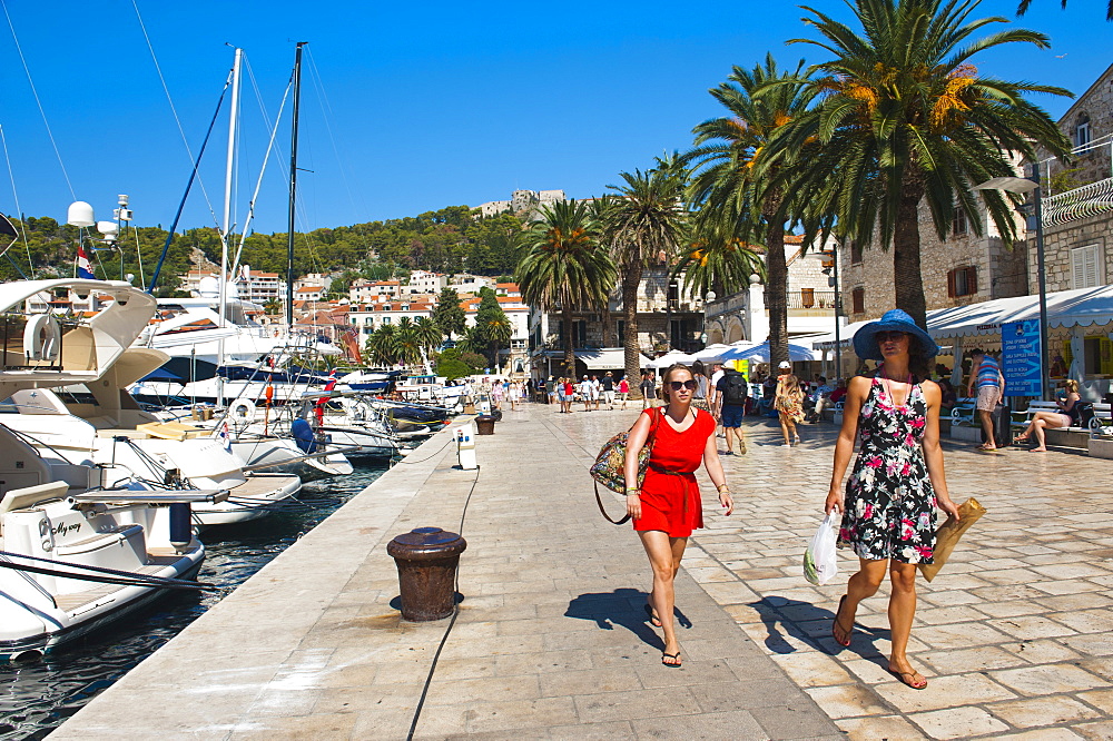 Tourists on a luxury holiday at Hvar Town Harbor, Hvar Island, Dalmatian Coast, Croatia, Europe