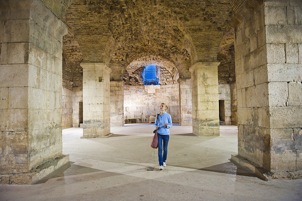 Tourist exploring the underground halls at Diocletian's Palace, UNESCO World Heritage Site, Split, Dalmatian Coast, Croatia, Europe 