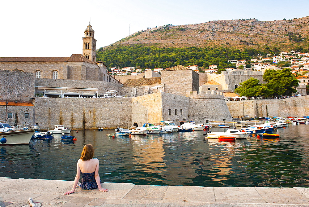 Tourist admiring Dominican Monastery, Dubrovnik Old Town, UNESCO World Heritage Site, Dubrovnik, Dalmatian Coast, Croatia, Europe 