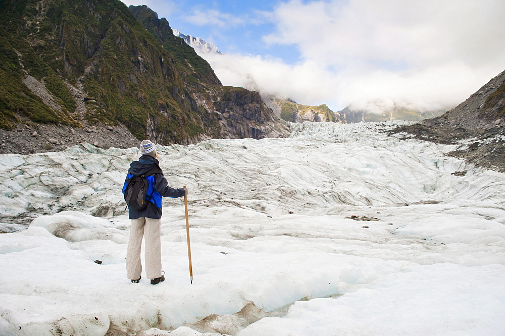 Female tourist walking on Fox Glacier, Westland National Park, UNESCO World Heritage Site, South Island, New Zealand, Pacific 