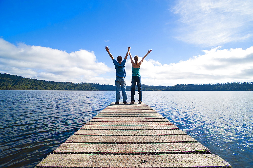 Couple on a jetty at Lake Ianthe, West Coast, South Island, New Zealand, Pacific 