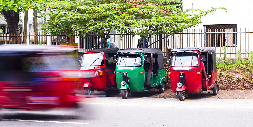 A tuk tuk speeding through the streets, Anuradahapura, North Central Province, Sri Lanka, Asia 