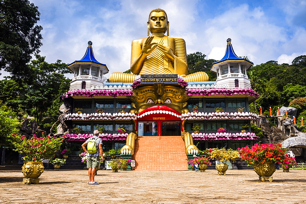 Tourist visiting the Golden Temple of Dambulla in Dambulla, Central Province, Sri Lanka, Asia