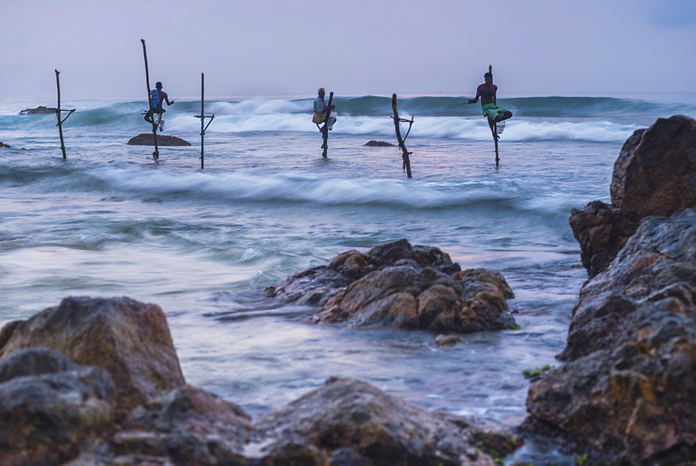 Stilt fishermen fishing at Midigama near Weligama, South Coast, Sri Lanka, Indian Ocean, Asia