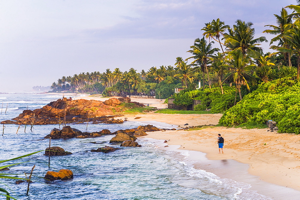 Tourist walking along Midigama Beach, near Weligama on the South Coast of Sri Lanka, Indian Ocean, Asia