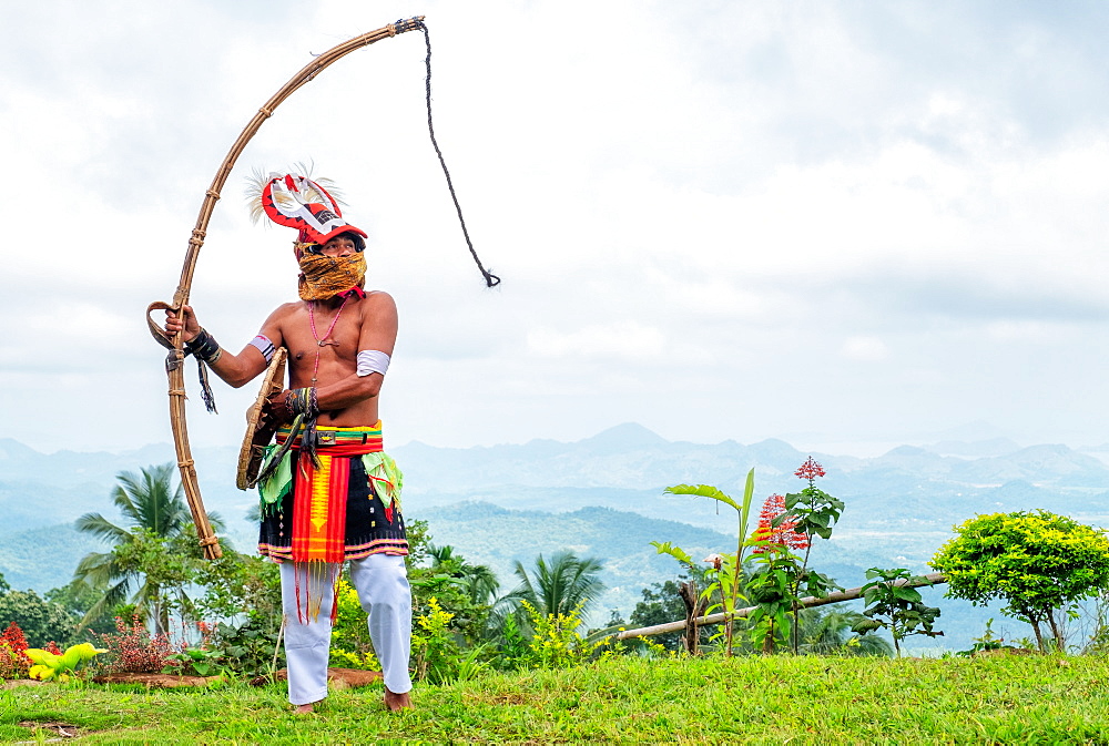 Caci man performing a traditional whip dance with bamboo shield and leather whip, western Flores, Indonesia, Southeast Asia, Asia