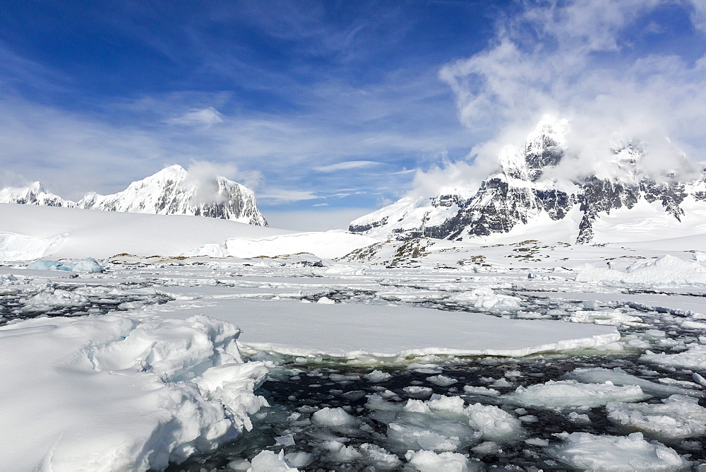 Snow-capped mountains surround Port Lockroy, Antarctica, Southern Ocean, Polar Regions