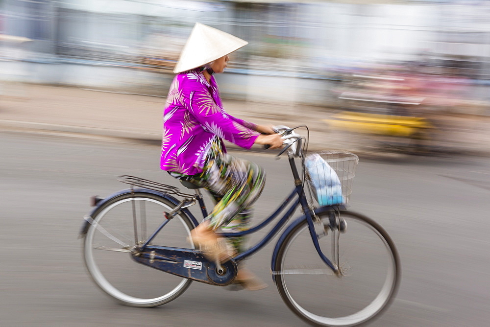 Woman on bicycle, slow shutter speed, Chau Doc, Mekong River Delta, Vietnam, Indochina, Southeast Asia, Asia