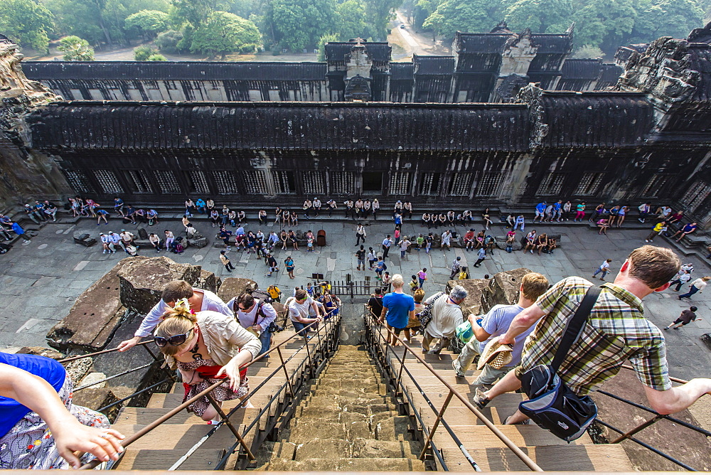 Tourists climb steps to the upper raised terrace at Angkor Wat, UNESCO World Heritage Site, Angkor, Siem Reap Province, Cambodia, Indochina, Southeast Asia, Asia