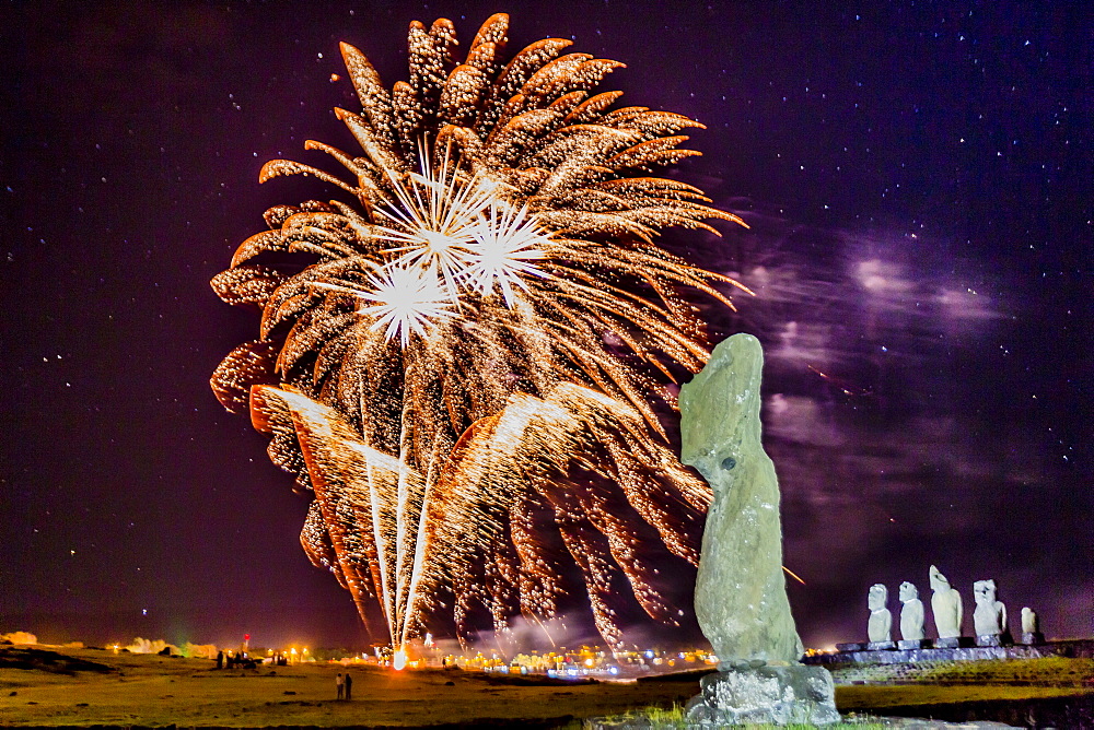 Fireworks ring in the New Year from the town of Hanga Roa over moai in the Tahai Archaeological Zone on Easter Island (Isla de Pascua) (Rapa Nui), UNESCO World Heritage Site, Chile, South America