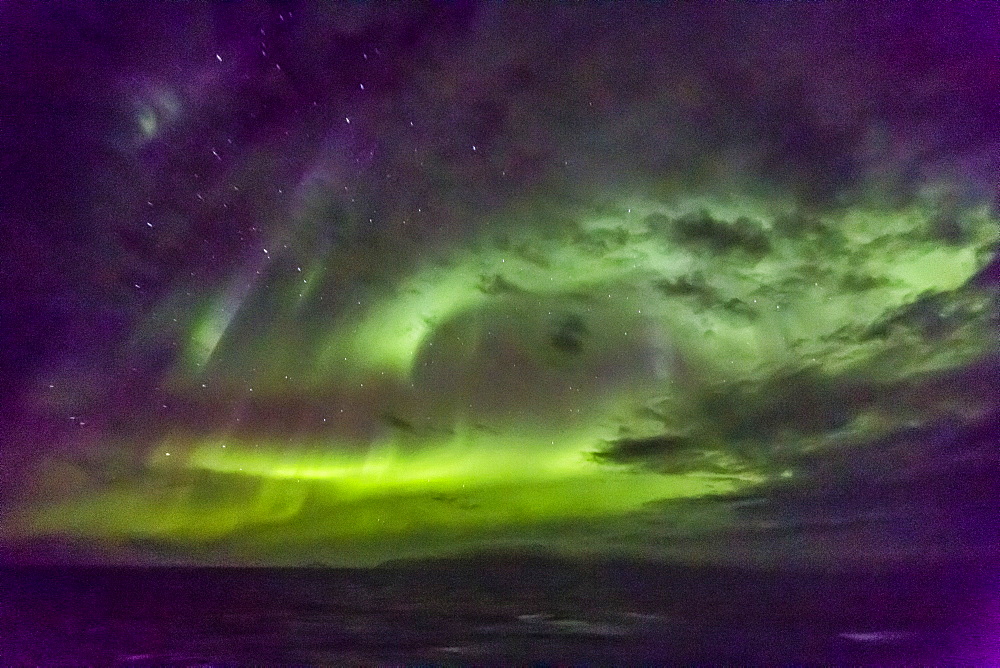 Aurora borealis (Northern Lights) dance above the Lindblad Expeditions ship National Geographic Explorer in Hudson Strait, Nunavut, Canada, North America 