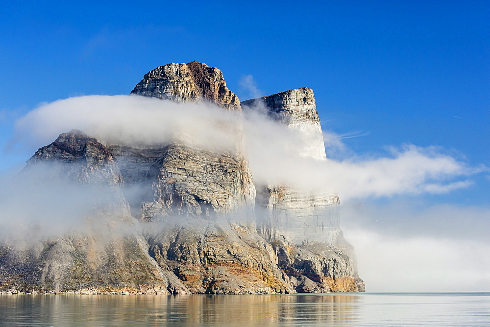 Fog lifting on the steep cliffs of Icy Arm, Baffin Island, Nunavut, Canada, North America 