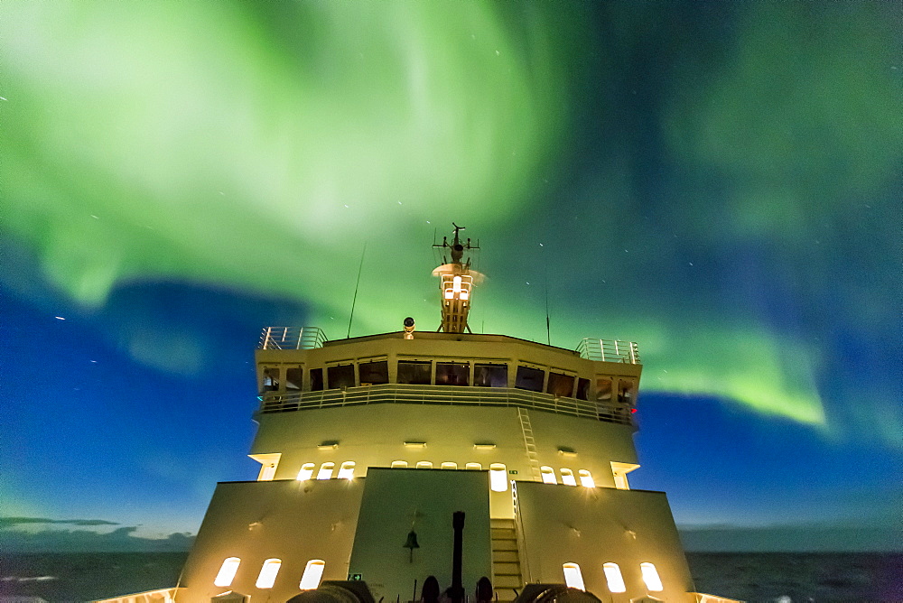 Aurora borealis (Northern Lights) dance above the Lindblad Expeditions ship National Geographic Explorer in Hudson Strait, Nunavut, Canada, North America