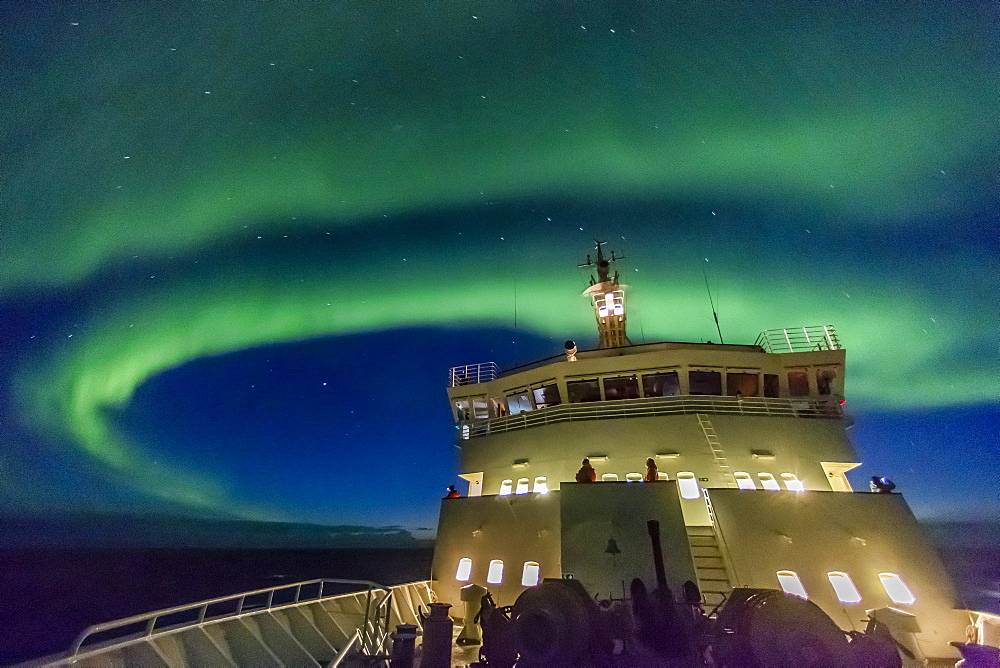 Aurora borealis (Northern Lights) dance above the Lindblad Expeditions ship National Geographic Explorer in Hudson Strait, Nunavut, Canada, North America