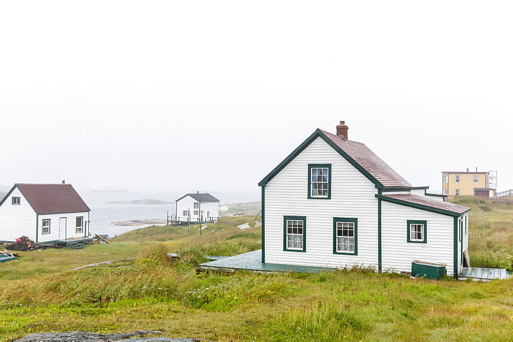 Fog rolls in over the small preserved fishing village of Battle Harbour, Labrador, Canada, North America 