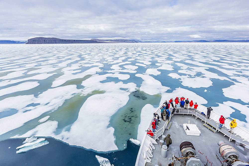 The Lindblad Expeditions ship National Geographic Explorer in Shorefast ice, Maxwell Bay, Devon Island, Nunavut, Canada, North America