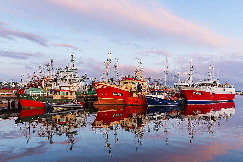 Sunset reflected on the commercial fishing fleet at Killybegs, the largest fishing port in Ireland, County Donegal, Ulster, Republic of Ireland, Europe