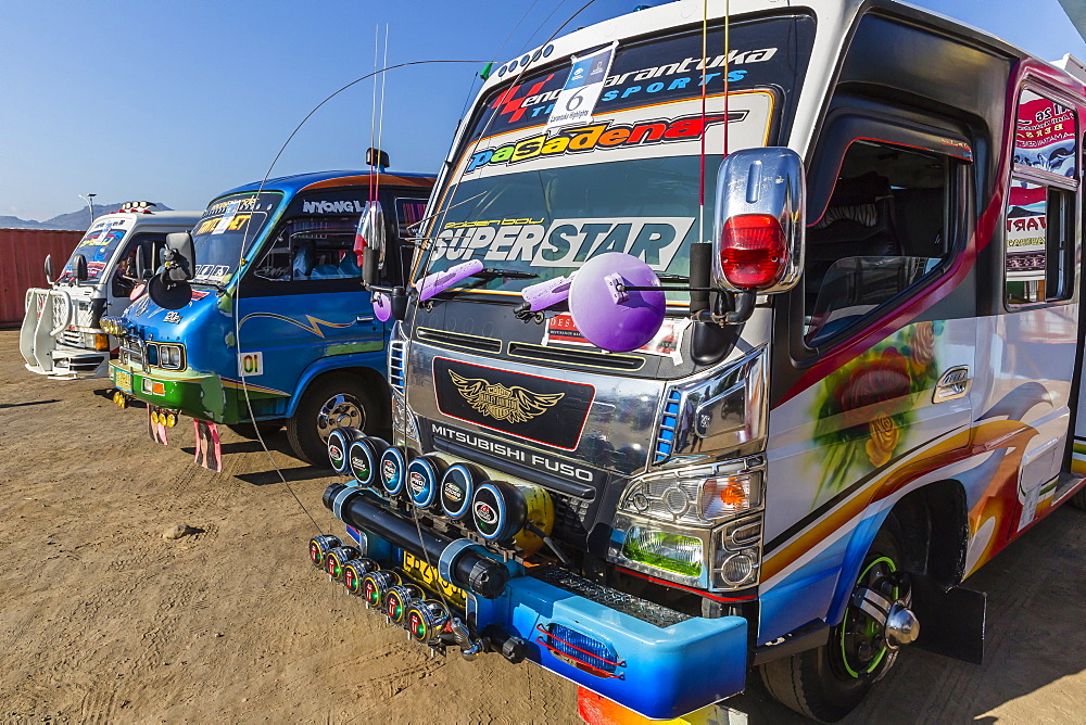 Highly decorated public buses in the busy port city of Larantuka, on Flores Island, Indonesia, Southeast Asia, Asia