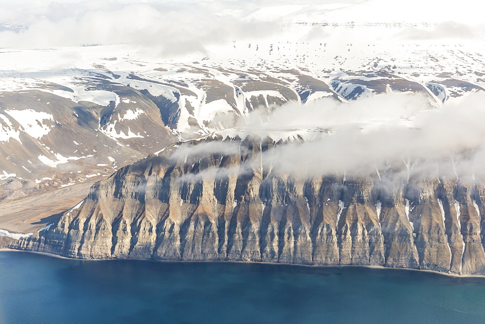 Aerial view of mountains, glaciers and ice fields on the west coast of Spitsbergen on a commercial flight from Longyearbyen to Oslo, Svalbard, Norway, Scandinavia, Europe