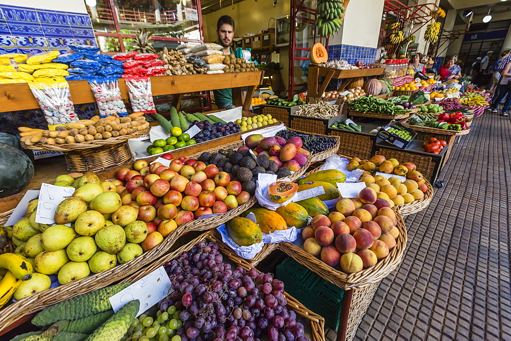 Vendors inside the Funchal Market, where fresh produce and fish are sold in Funchal, Madeira, Portugal, Europe