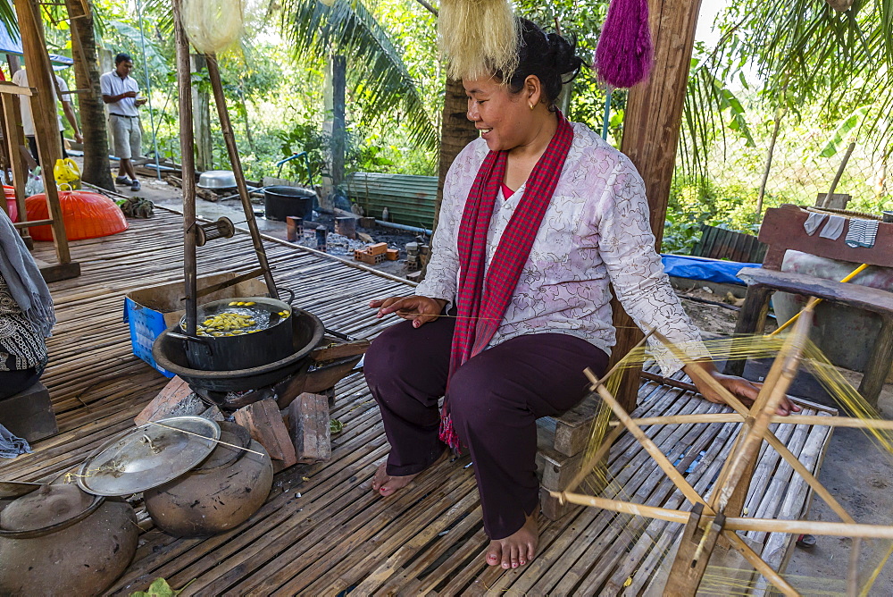 Hand spinning silk from silk worms in the village of Koh Oaknha Tey, Cambodia, Indochina, Southeast Asia, Asia