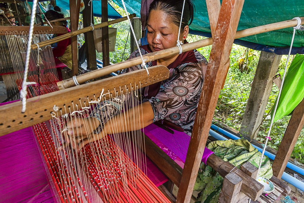 Hand weaving silk on a wooden loom in the village of Koh Oaknha Tey, Cambodia, Indochina, Southeast Asia, Asia