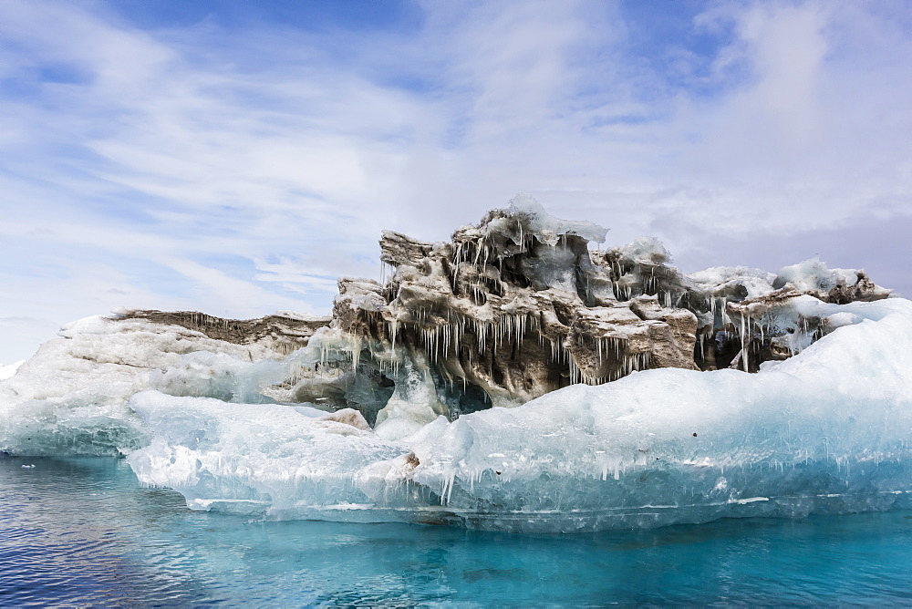 Iceberg with moraine material and icicles at Booth Island, Antarctica, Polar Regions