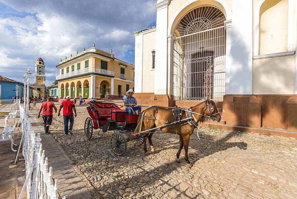 A horse-drawn cart known locally as a coche in Plaza Mayor, in the town of Trinidad, UNESCO World Heritage Site, Cuba, West Indies, Caribbean, Central America