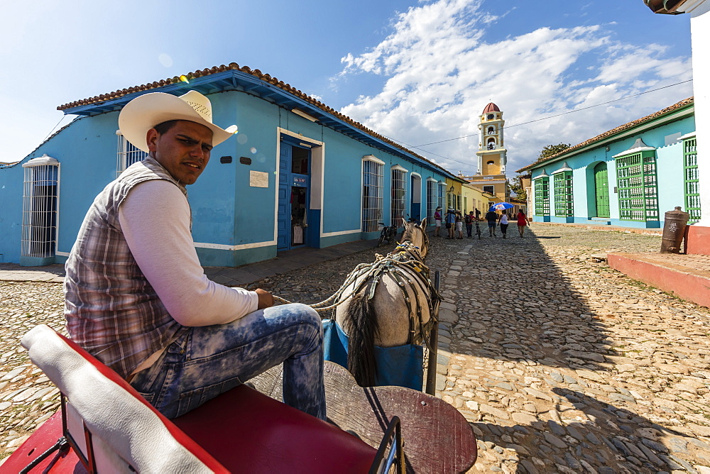 A horse-drawn cart known locally as a coche in Plaza Mayor, in the town of Trinidad, UNESCO World Heritage Site, Cuba, West Indies, Caribbean, Central America