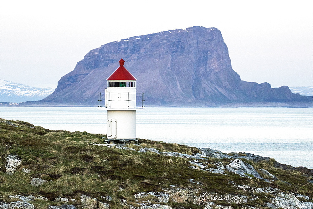 Sunset over the lighthouse in the fishing town of Trana, located on the Arctic Circle, Norway, Scandinavia, Europe