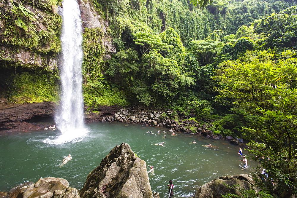 Tourists enjoy the refreshing cool waters of a waterfall on Taveuni Island, Republic of Fiji, South Pacific Islands, Pacific