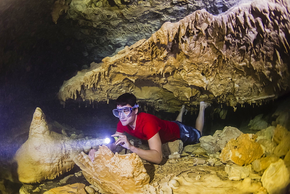 A snorkeler explores the fresh water grotto formations at Makatea, Tuamotus, French Polynesia, South Pacific, Pacific