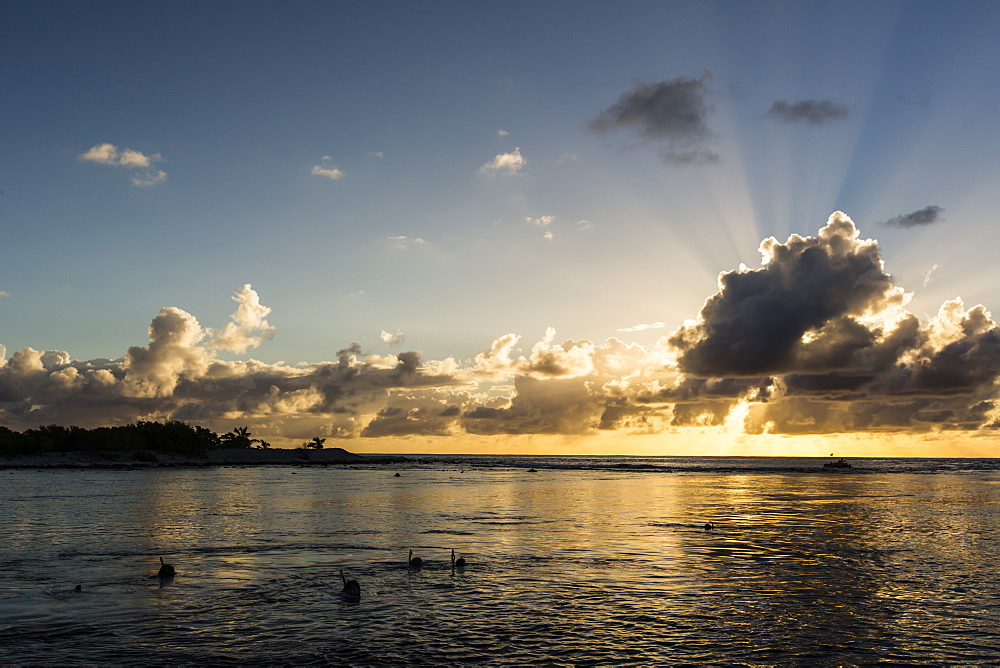 Snorkelers at sunset at Niau Atoll, Tuamotus, French Polynesia, South Pacific, Pacific