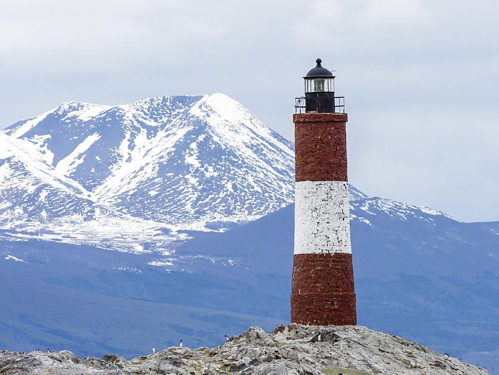 Lighthouse with Andes Mountains in the background on a small islet in the Beagle Channel, Ushuaia, Argentina, South America