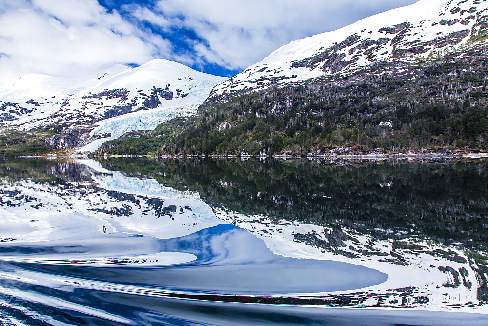 Reflections in calm water in the Strait of Magellan, Patagonia, Chile, South America