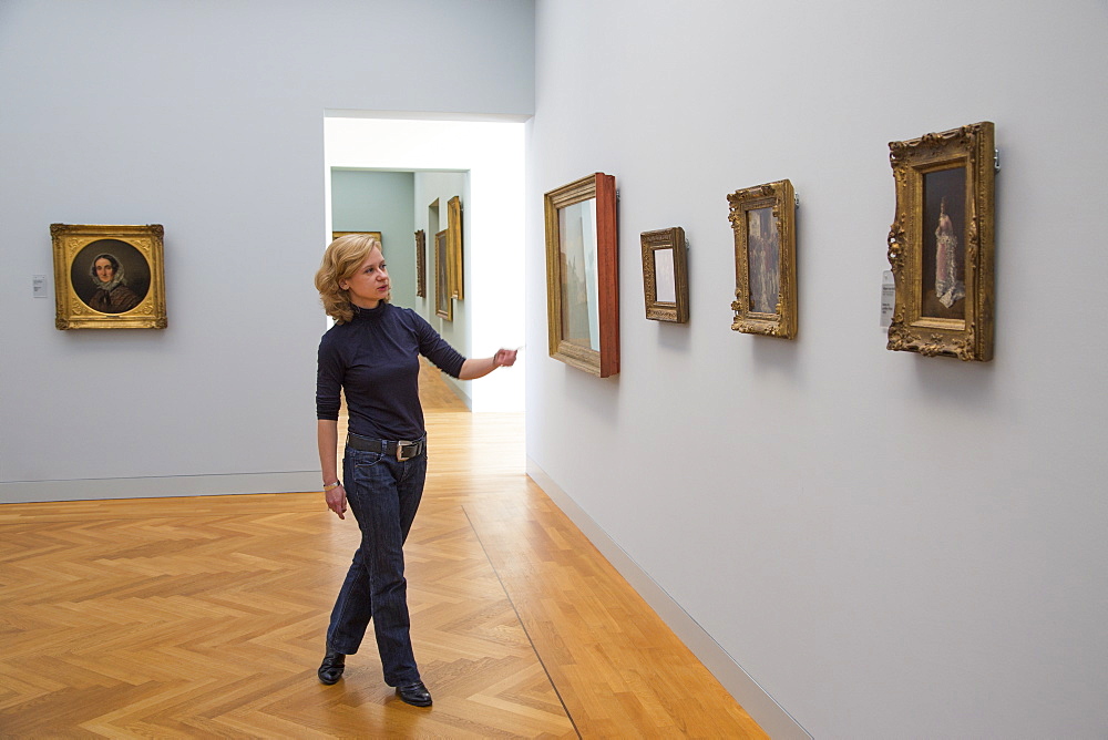 Woman explaining artwork in the Georg Schaefer Museum, Schweinfurt, Franconia, Bavaria, Germany