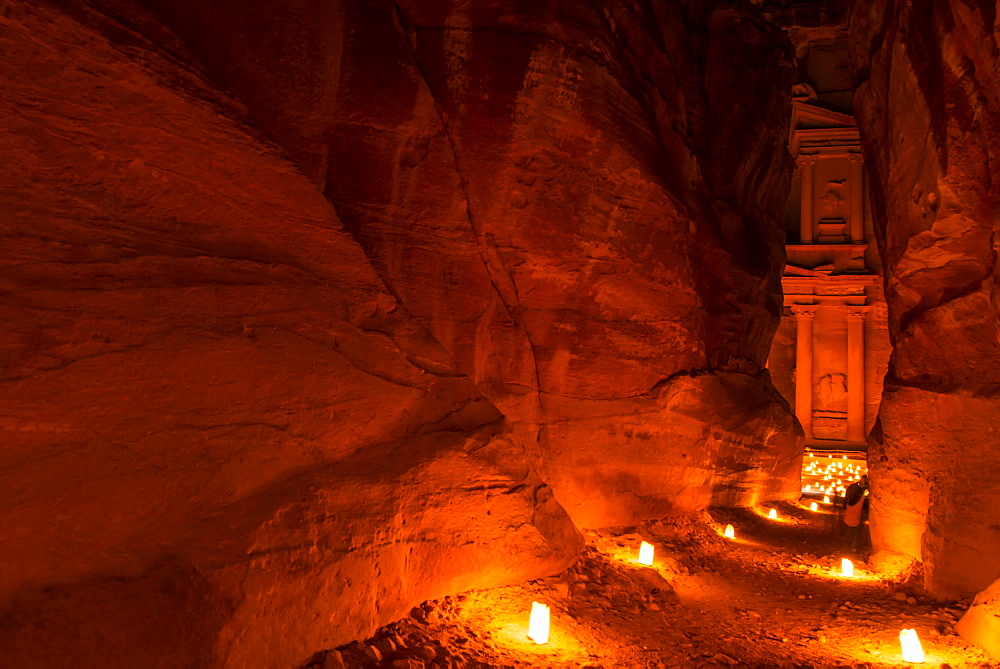 View through The Siq to Al Khazneh at night, Petra, Jordan, Middle East