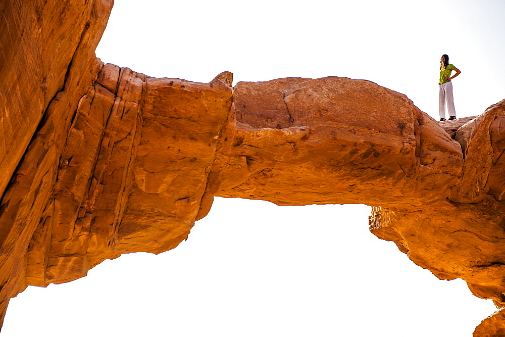 Woman standing on Jabal Umm Fruth Rock Bridge, Wadi Rum, Jordan, Middle East