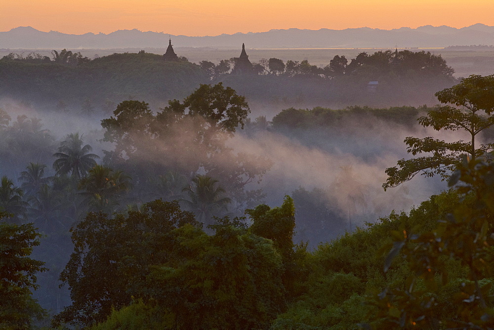 View above hill the hills and pagodas in the evening mist at Mrauk U, Myohaung north of Sittwe, Akyab, Rakhaing State, Arakan, Myanmar, Burma