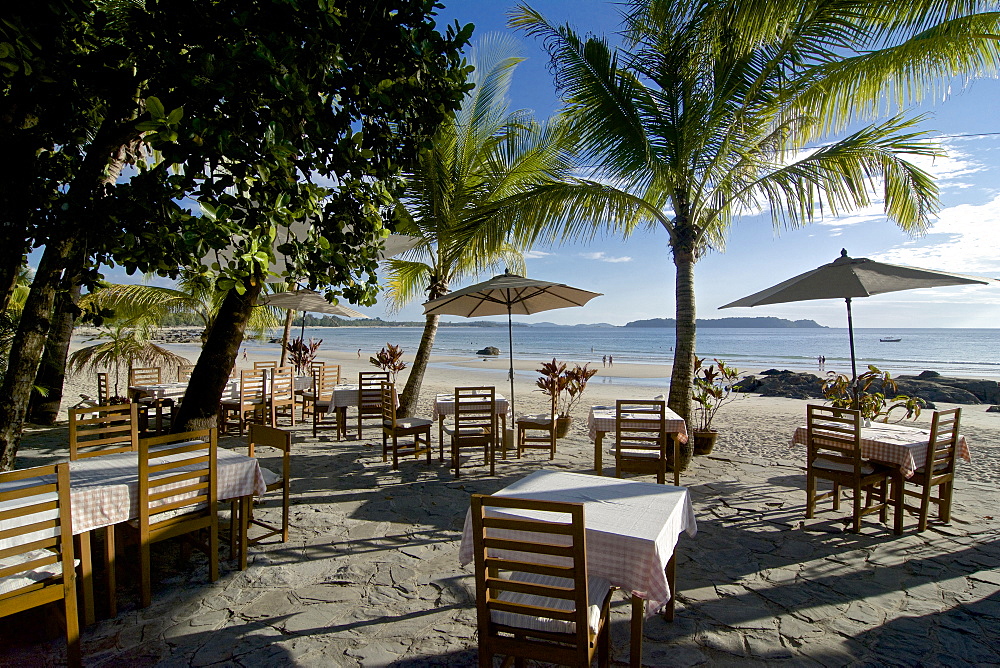 Dining tables under palm trees, Ngapali, most famous beach resort in Burma at the Bay of Bengal, Rakhaing State, Arakan, Myanmar, Burma